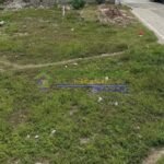 An aerial view of an overgrown, grassy vacant lot.