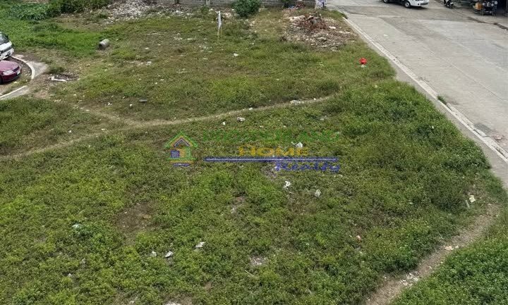 An aerial view of an overgrown, grassy vacant lot.