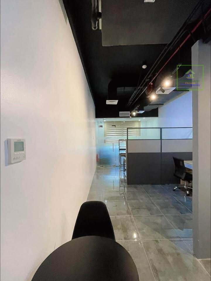 A view into an office space with a black chair in the foreground.