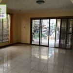 A vacant room with tiled floor, sliding glass doors, and a window.