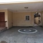 Covered parking area with a Prosperland Home Realty logo.