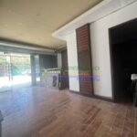 Interior view of a commercial space with glass doors and decorative wood panels.