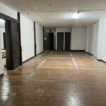 Empty commercial space with tile flooring and white walls.