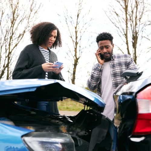 Couple Exchanging Car Insurance Details After Road Traffic Accident