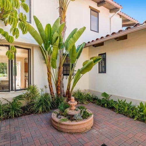 this house is very nice with lots of greenery on the yard