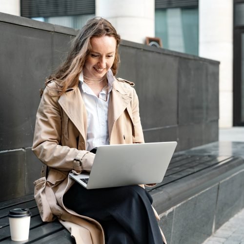 young specialist in commercial real estate works online. A happy contented young woman